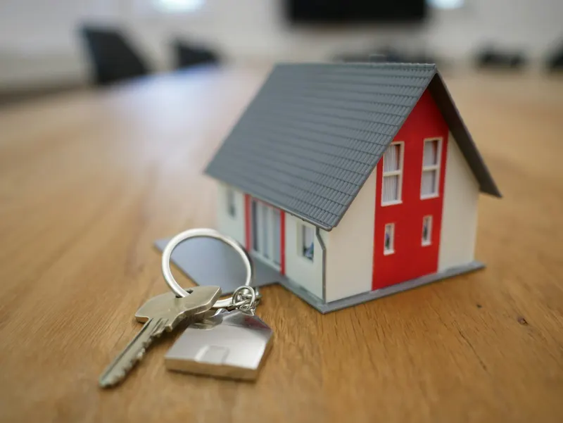 House keys on a wooden table symbolizing a first home purchase